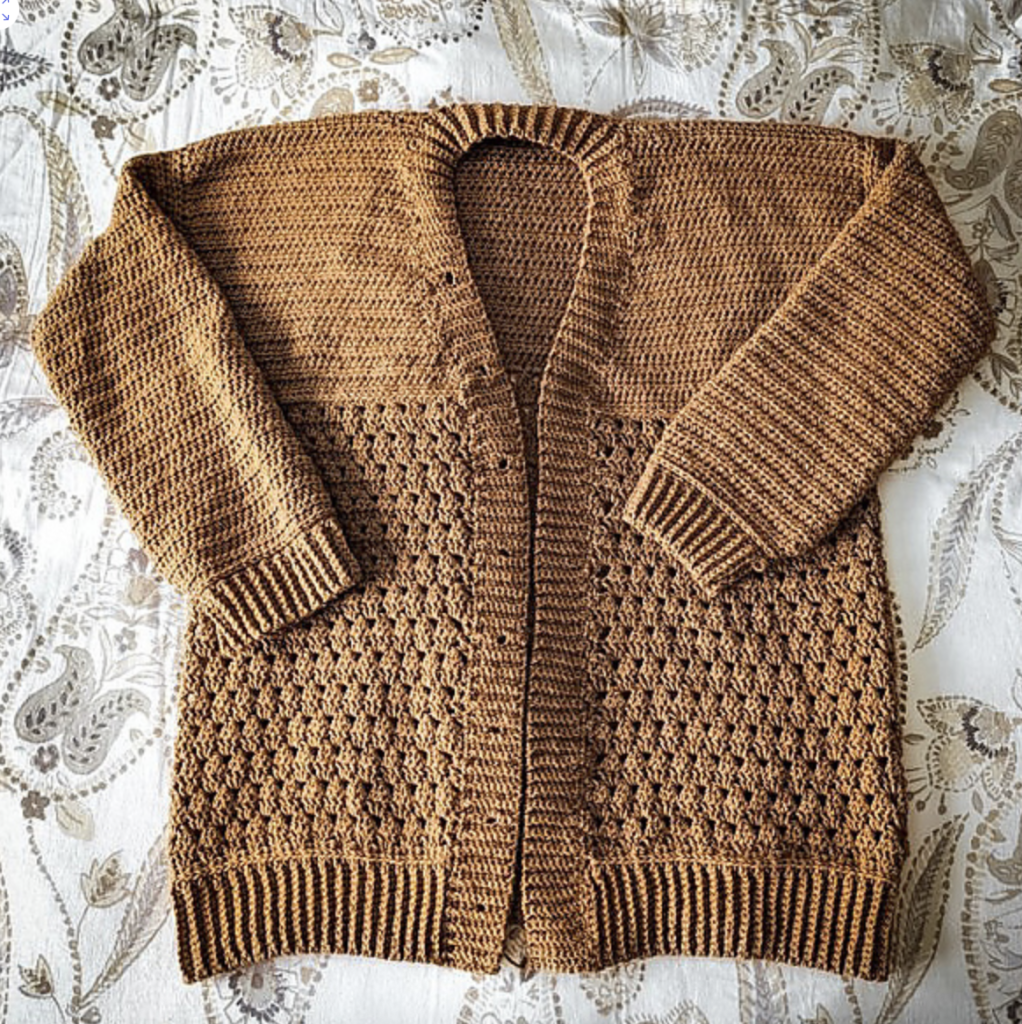 Brown Pine crochet cardigan laid flat, featuring textured granny stitch panels, solid sleeves and ribbed edging.